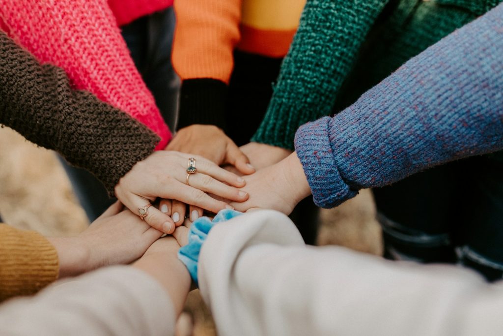 many hands team of people with their hands joined