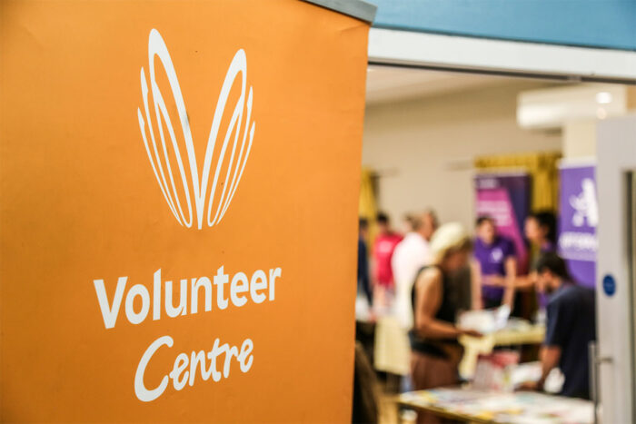 VVC Volunteer Fair VVC Volunteer Fair - image of orange banner and people at the fair