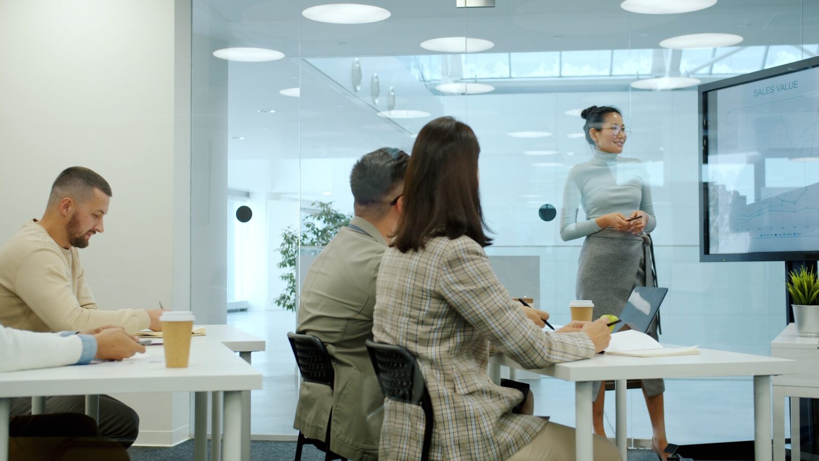 Woman delivering training in a modern office meeting.