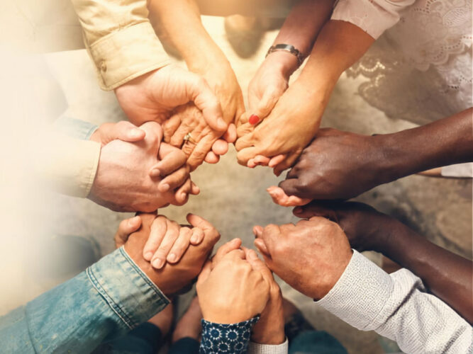 Close-up of group of hands holding in a circle