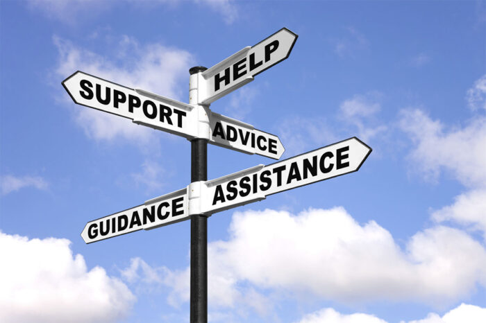Help and support signpost Signpost with the words Help, Support, Advice, Guidance and Assistance on the direction arrows, against a bright blue cloudy sky.
